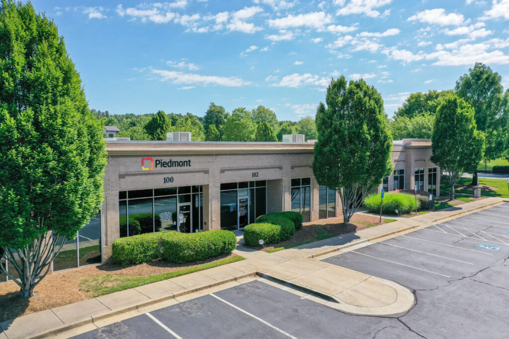 Aerial view of ambulatory medical facility with parking lot.