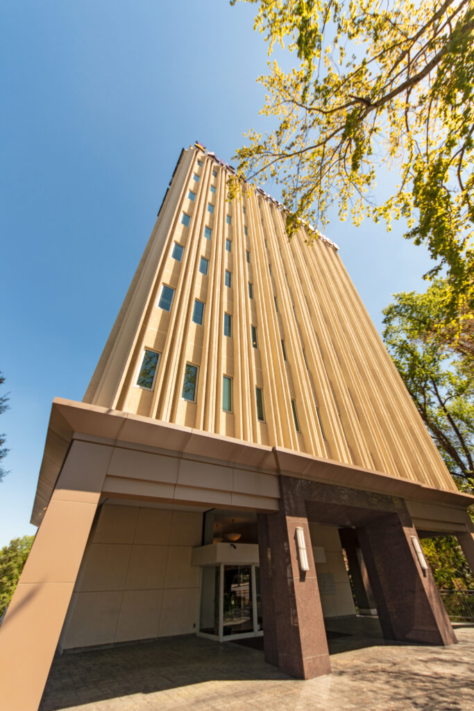 Image from the ground looking up a tall medical facility.