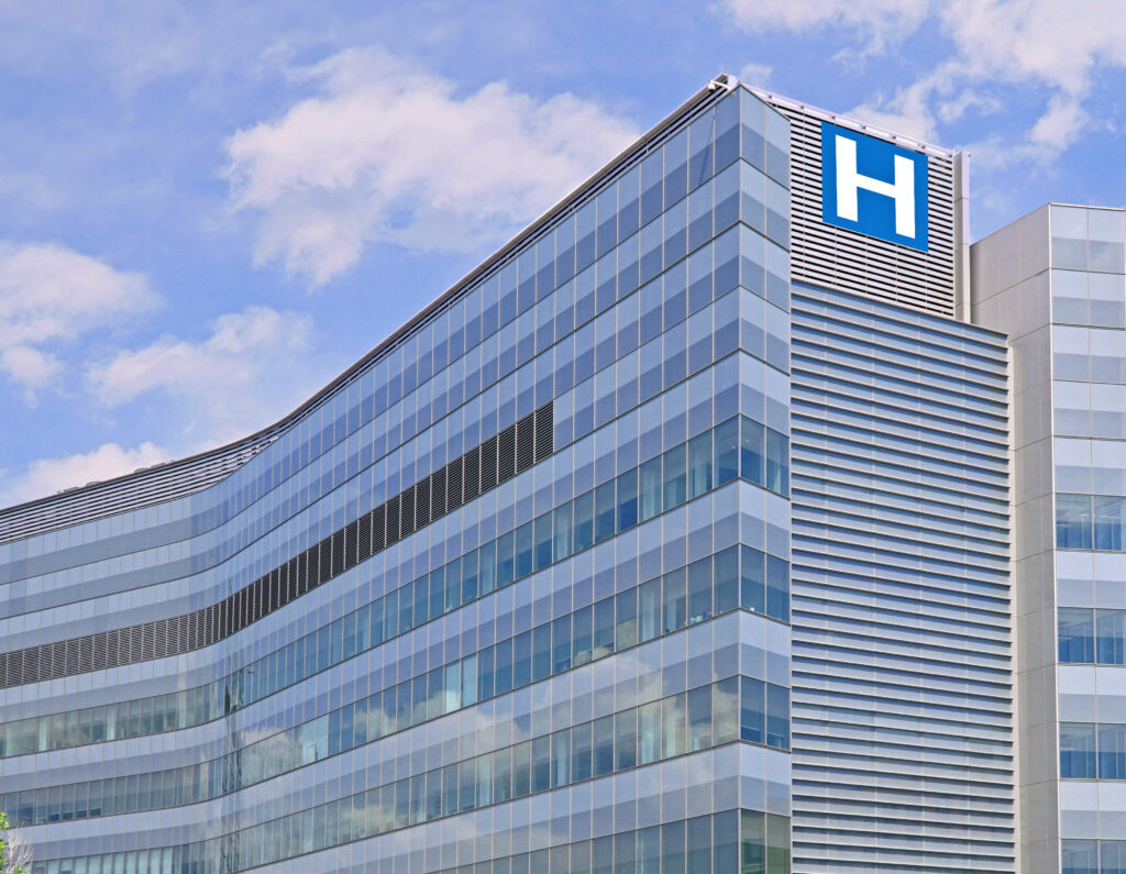 Building with large H sign for hospital.