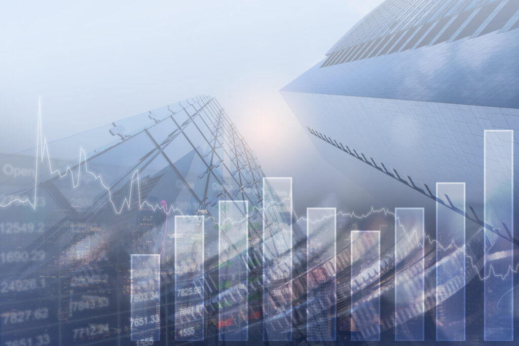 Double exposure of skyscraper, overlayed with a financial graph for business.